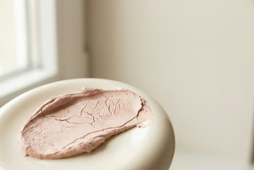 A swatch of pink clay beginning to craze on cream ceramic